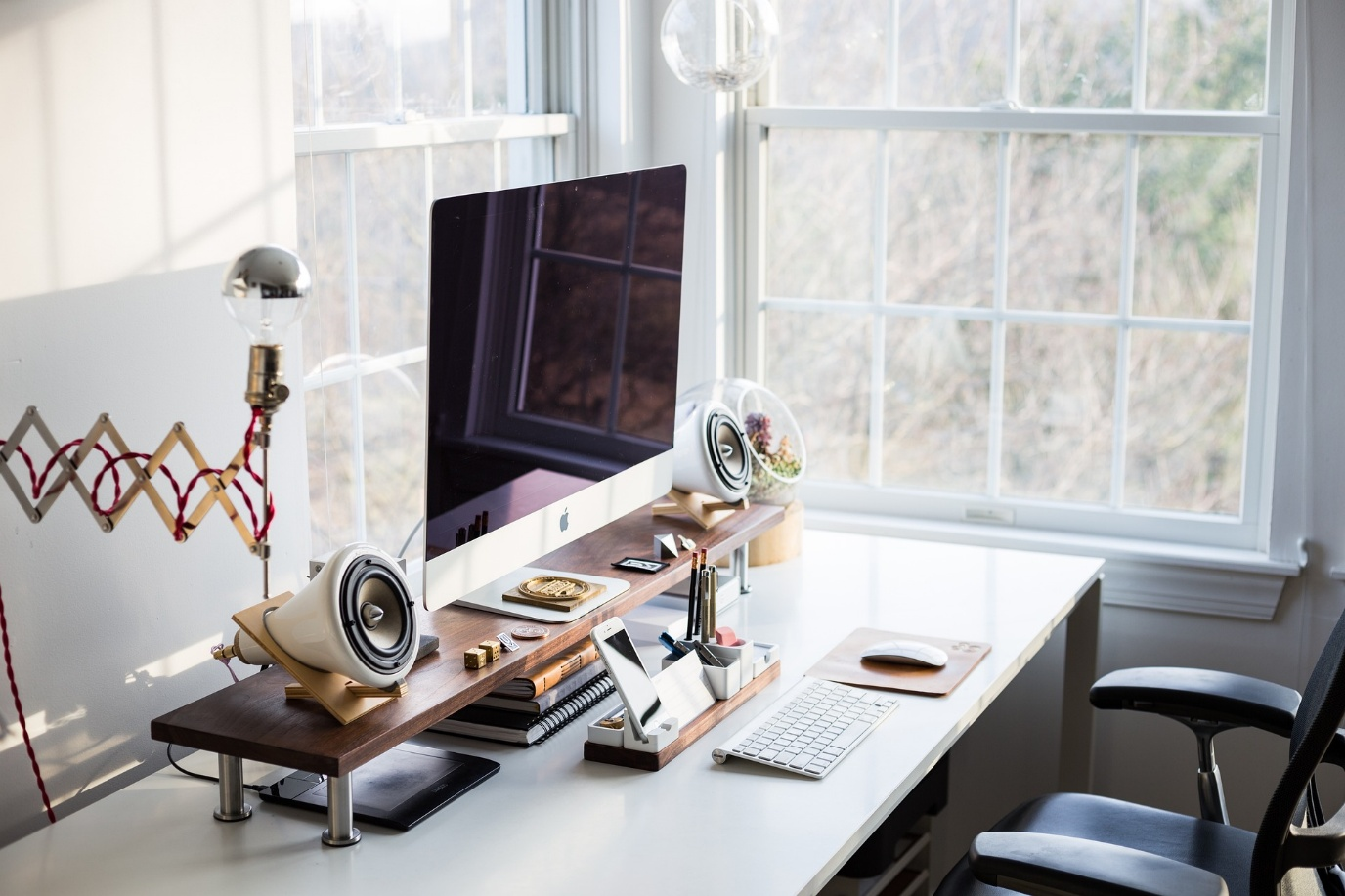 a desk with a computer and speakers